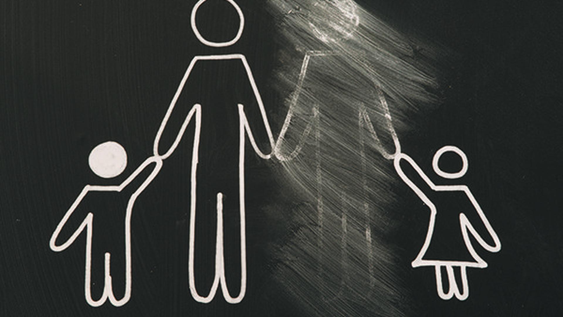 Chalk drawing of a family on a blackboard with one parent figure erased — symbolising the alienated parent